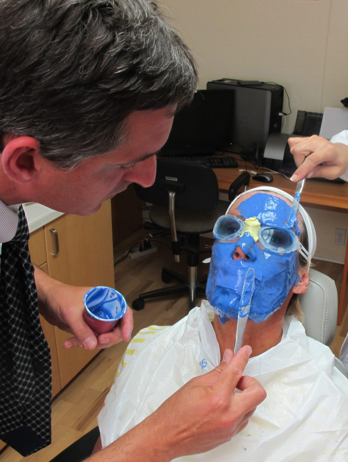 Image shows Stefan Knauss, co-owner of and prosthetist at Aesthetic Prosthetics Inc., creating the silicone mask for long-distance swimmer Diana Nyad.